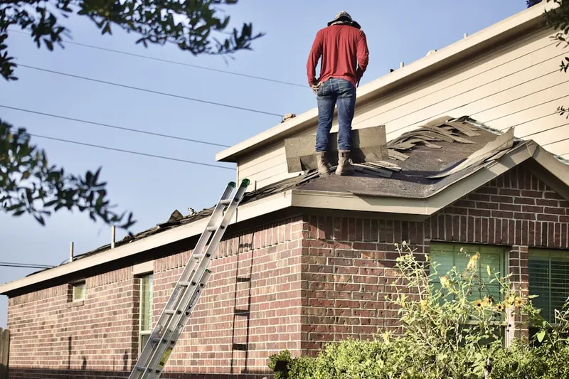 Professional roofer working on a residential roof in St. John